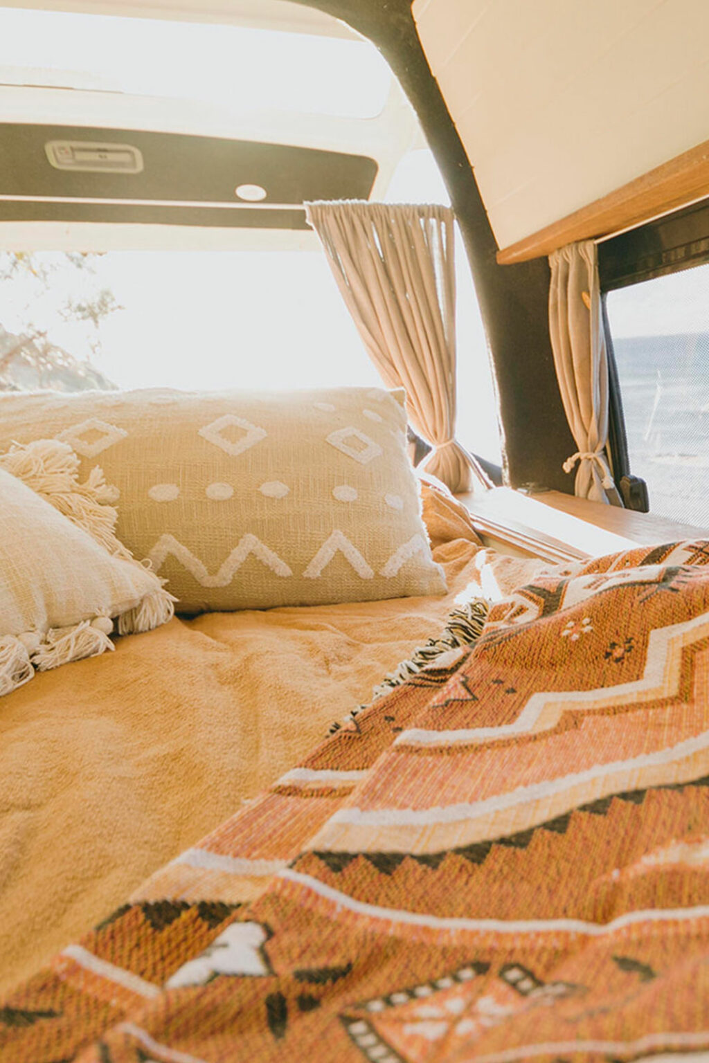 Campervan interior with bed and curtains